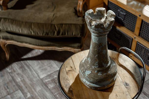 high angle view of big chess figure on wooden table in modern retro styled living room - Fotó, kép