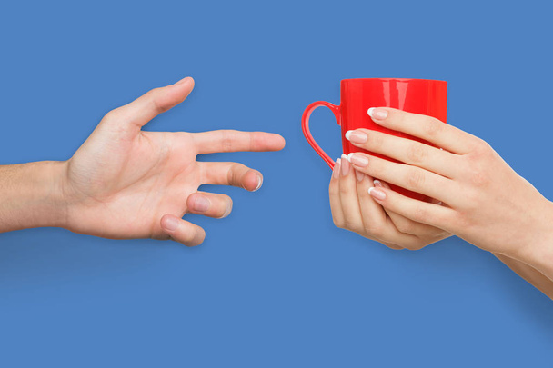Woman giving cup of coffee to her man - Photo, image