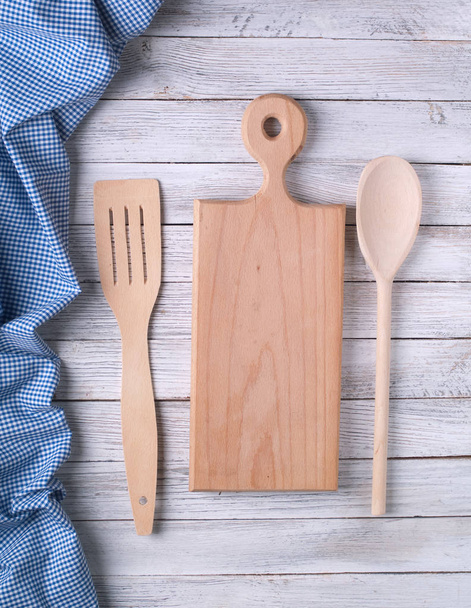 cutting board , spoon and tablecloth on wooden table - Photo, Image