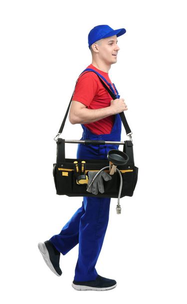 Young plumber with tool bag on white background - Photo, image