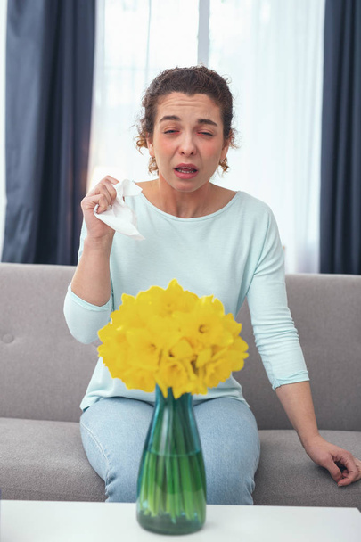 Young housewife being allergic to flower pollen - Foto, Imagen