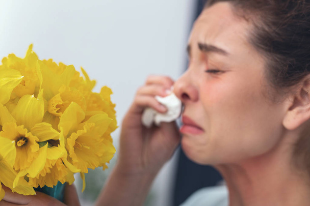 Upset girl crying over a bouquet of beautiful flowers - Photo, Image