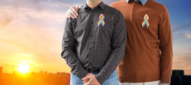 close up of couple with gay pride rainbow ribbons - Photo, Image