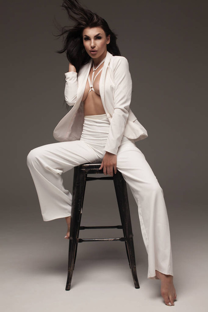 Sexy young woman wearing white suit - Zdjęcie, obraz