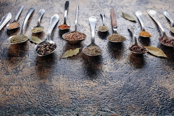 Different spices in  spoons on a vintage background. Copy space for your text. - Fotoğraf, Görsel