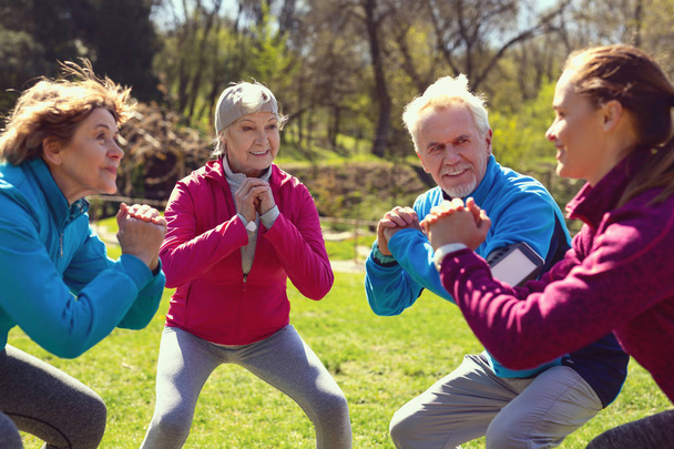 Inspired aged people exercising in the park - Photo, Image