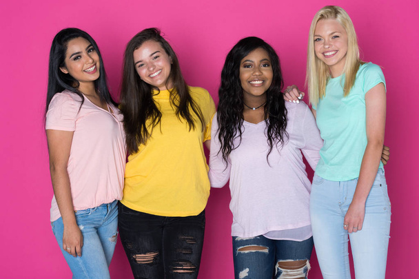 Group of very diverse teen friends on pink background - Valokuva, kuva