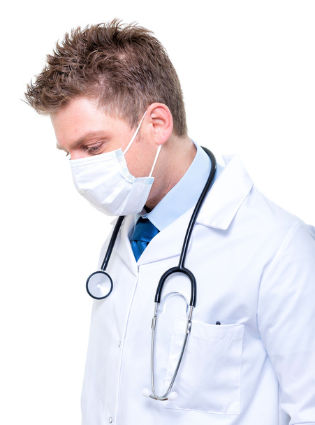 Portrait of male doctor wearing surgical mask - Foto, immagini