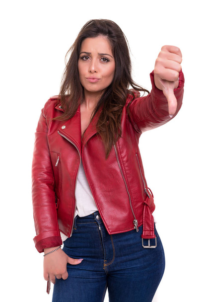 Студійний знімок молодої жінки, що сигналізує великі пальці вниз
 - Фото, зображення