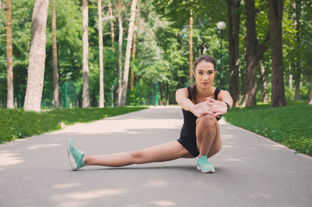 Fitness woman at stretching training outdoors - Fotó, kép