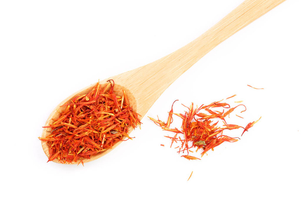 Heap of saffron in wooden spoon isolated on white background. Top view. Flat lay - Photo, Image