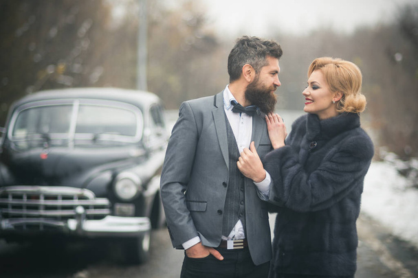 sexy woman in luxury fashion coat and man driver. sexy woman with stylish hair and makeup at driver in retro car - Fotografie, Obrázek