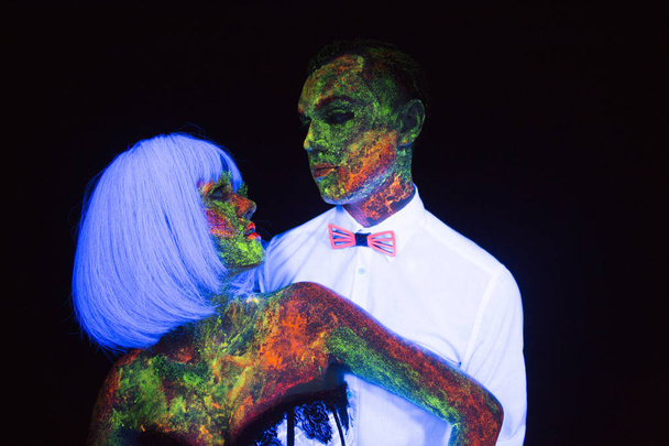 Neon lovestory photography in the rays of the ultraviolet couple in love guy and girl bride with the groom at the wedding UV radiation - Photo, Image