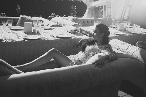 Sweet holiday day. Celebration luxury concept. Girl in party dress lying on sofa in restaurant - Φωτογραφία, εικόνα