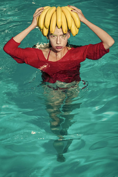Dieting and healthy organic food, vegetarian. dieting with fresh banana fruit of woman in pool. Fashion woman model posing. - 写真・画像