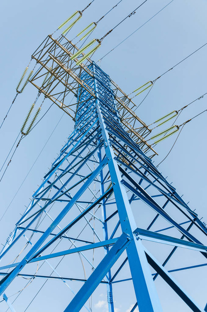 High voltage electric tower. New painted power line masts - Photo, Image
