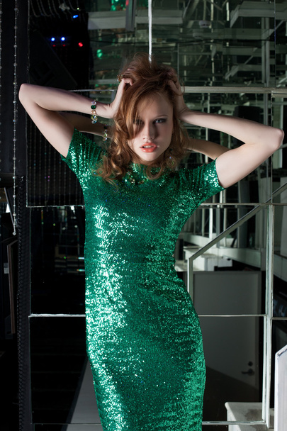 Young aggressive woman in green fashion dress - 写真・画像