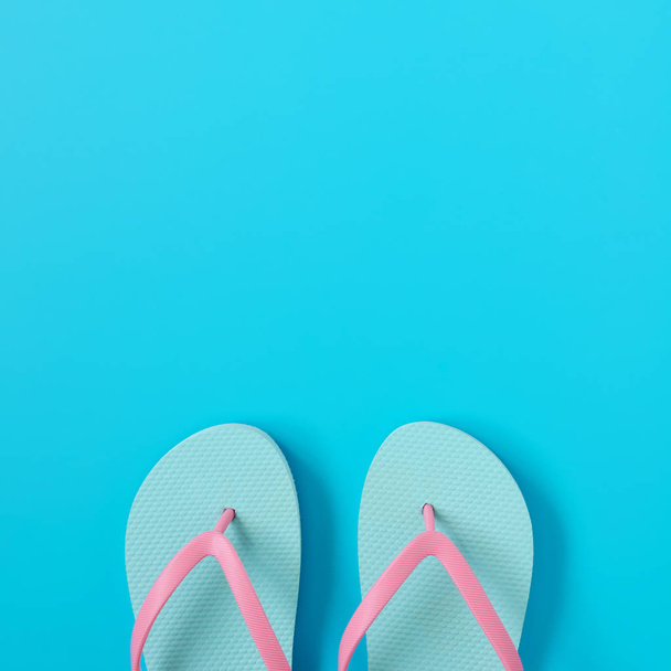 Flip-flops on blue background. Summer concept. Copy space composition - Zdjęcie, obraz