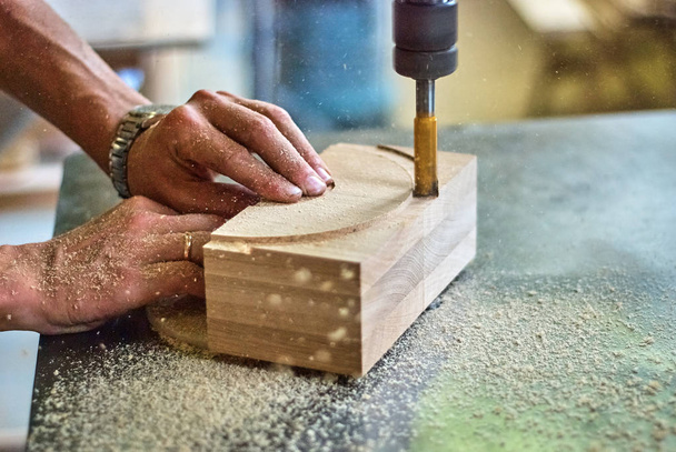 Processing of wooden products with a milling machine in a joinery workshop - Foto, immagini