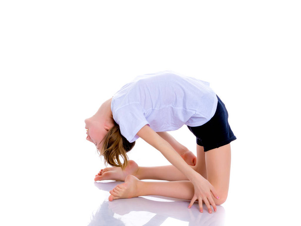 The gymnast perform an acrobatic element on the floor. - Fotografie, Obrázek