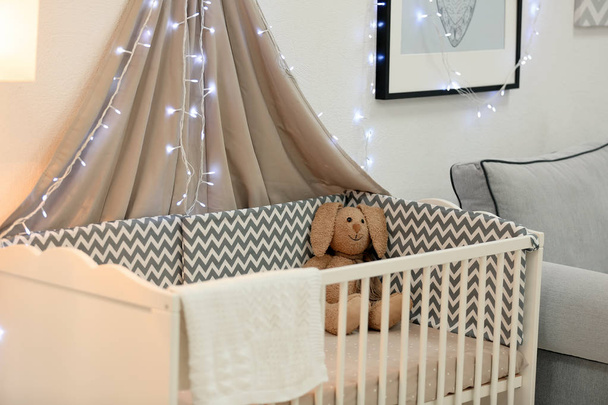 Modern interior of light baby room with crib - Photo, image
