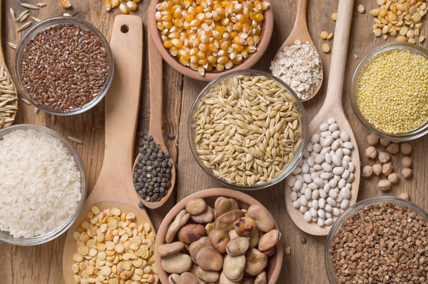 Cereal grains , seeds, beans on wooden background. - 写真・画像