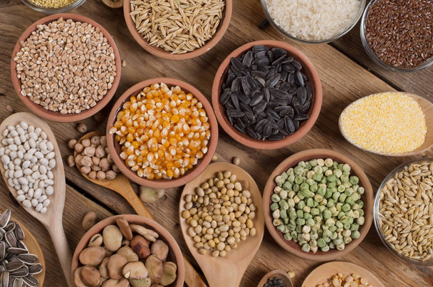 Cereal grains , seeds, beans on wooden background. - Fotó, kép