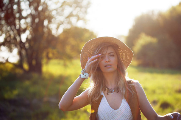 Cute charming girl in summer in the field. Young woman is happy and feels free outdoors - Foto, imagen