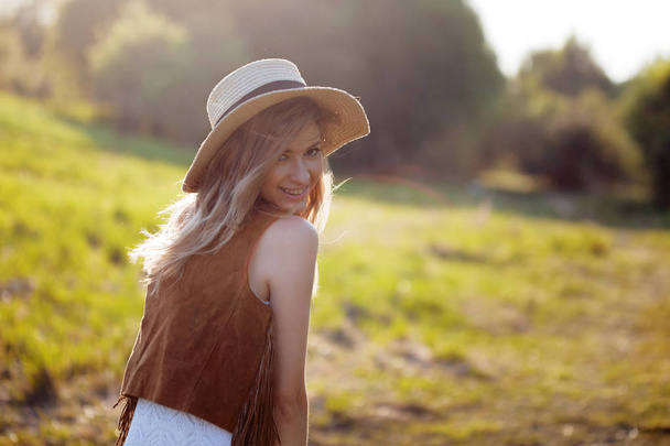 Cute charming girl in summer in the field. Young woman is happy and feels free outdoors - Photo, image