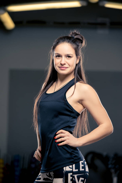 young brunette posing in sports hall, vertical portrait, women - Foto, Imagem