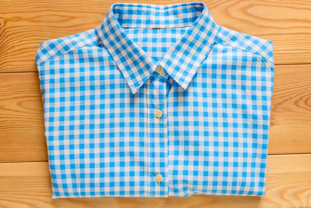 Dámská kostkovaná košile pohled shora na dřevěných desek - Fotografie, Obrázek