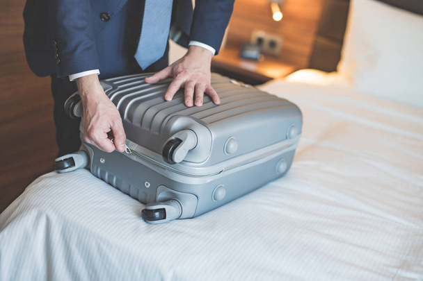 Young businessman with a suitcase closeup - Photo, Image