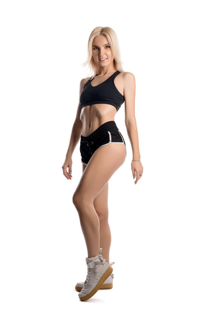 Slim fitness trainer in sportswear isolated shot - Photo, image