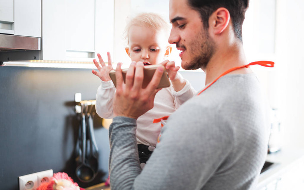 Father and daughter enjoying time together in kitchen - Photo, image