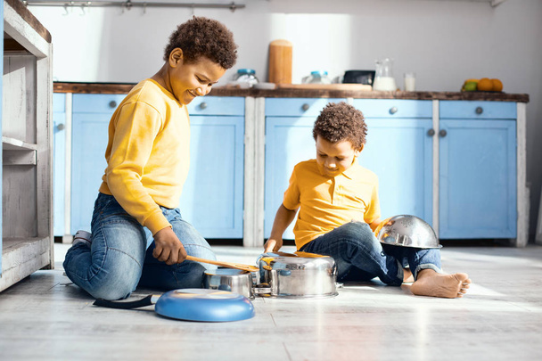 Cheerful little kids drumming on saucepans in kitchen - Φωτογραφία, εικόνα