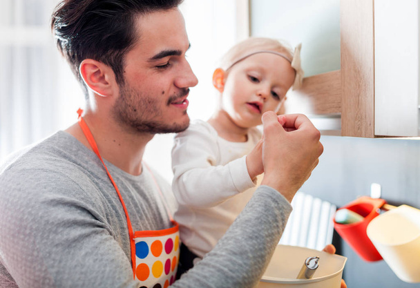 Father and daughter enjoying time together in kitchen - Photo, Image
