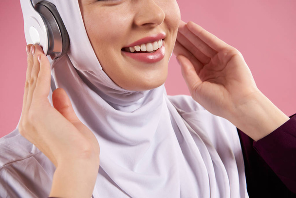 Close up. Arab woman in hijab listens to music - Photo, image