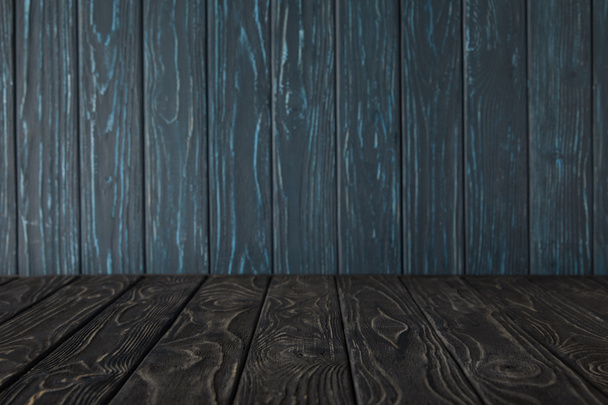 dark grey wooden table and dark blue wooden wall - Foto, Imagem