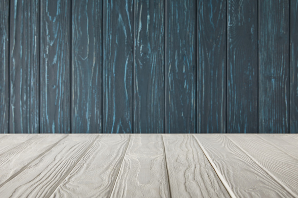 weiß gestreifte Tischplatte und dunkelblaue Holzwand - Foto, Bild