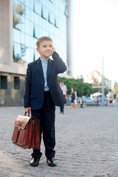 Future businessman with briefcase and phone - Photo, image