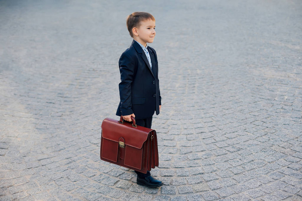 Future businessman in formal costume with briefcase - Foto, Bild