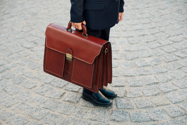 Hand holding business leather braun briefcase  - Photo, Image