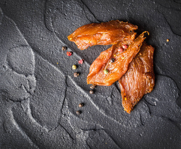 Chicken jerky, from pieces of fillet in soy sauce - Fotó, kép