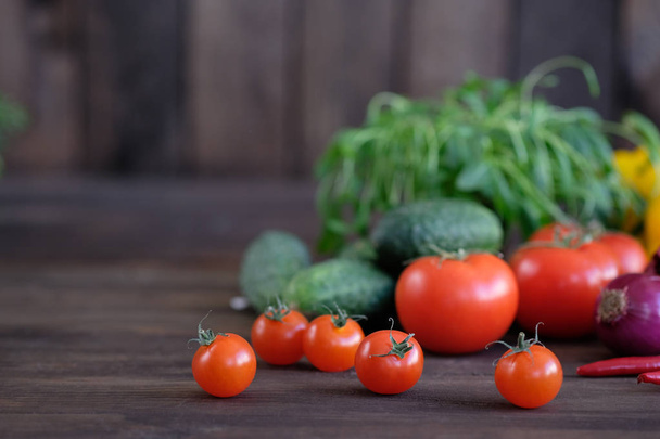 Vegetable.Fresh vegetables: tomatos, cucumbers,peppers and green seasonings on  old rustic oak table. - Foto, Imagem