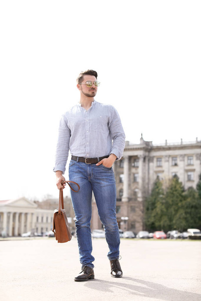 Handsome young man in stylish outfit and leather shoes outdoors - Zdjęcie, obraz