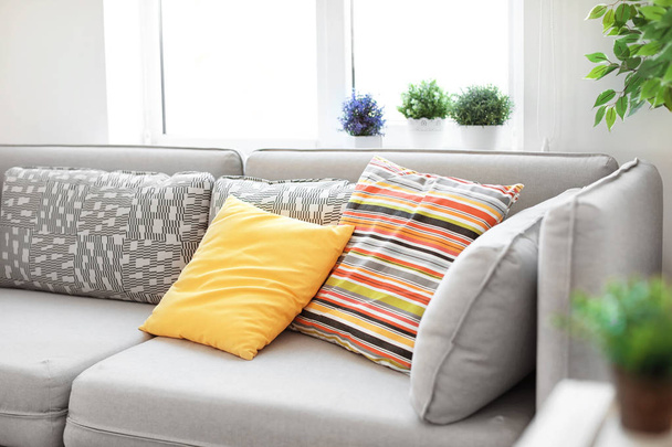Interior of modern living room with pillows on sofa - Foto, Imagem