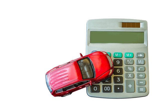 Calculator and toy red car isolated on white background - 写真・画像