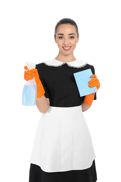 Young chambermaid with rag and detergent on white background - Фото, зображення