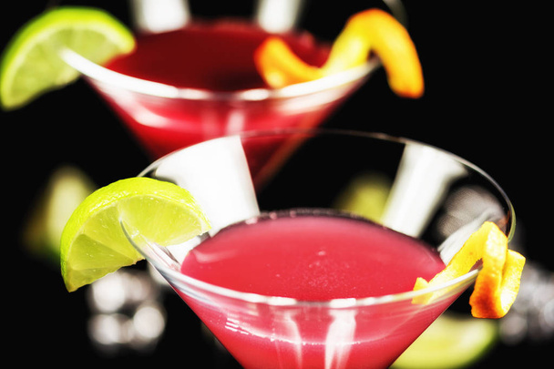 Alcohol drink cocktail Cosmopolitan with lime on black background - Photo, Image