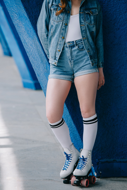 cropped shot of stylish woman in denim clothes, high socks and retro roller skates - Fotografie, Obrázek